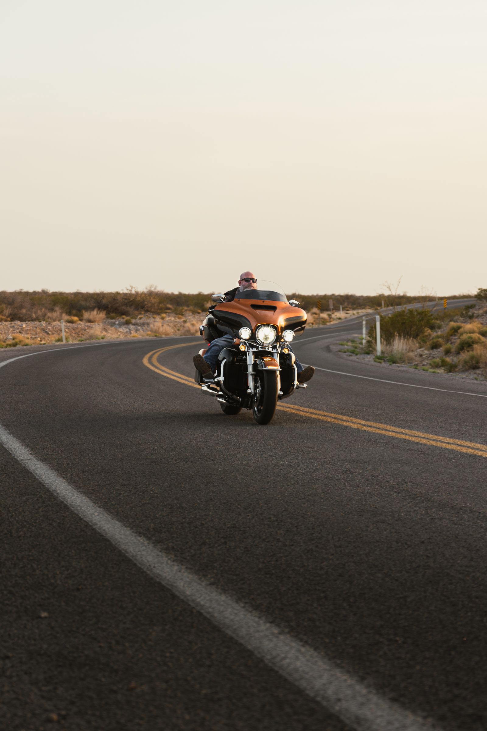 Motorcycle on a scenic road at sunset